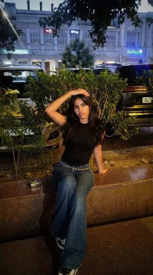 Night Flash look: the same woman lit by a harsh direct flash, the street behind her dark